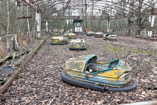 Attraction in amusement park in overgrown ghost city Pripyat near Chernobyl nuclear power plant in Ukraine.