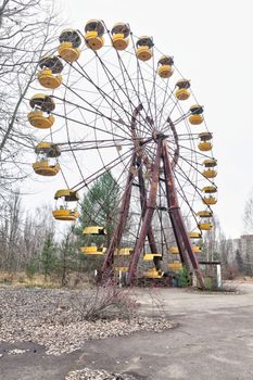 Attraction in amusement park in overgrown ghost city Pripyat near Chernobyl nuclear power plant in Ukraine.