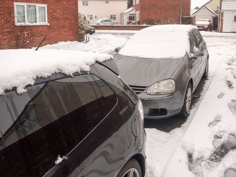 snow on top of parked cars outside front street residential area; essex; england; uk