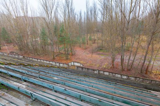 Overgrown stadium in ghost city Pripyat near Chernobyl nuclear power plant in Ukraine.