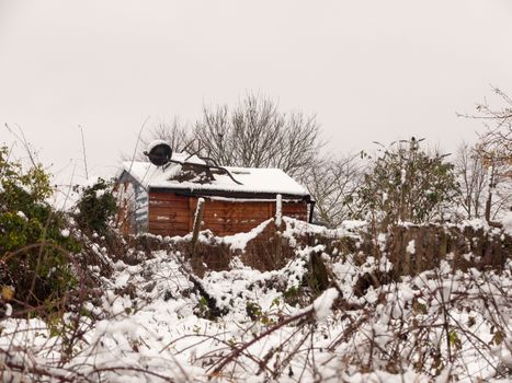 winter snow covered outside country field scene shed covered december close up; essex; england; uk