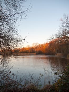 autumn lake scene outside sun set light space surface winter clear; essex; england; uk