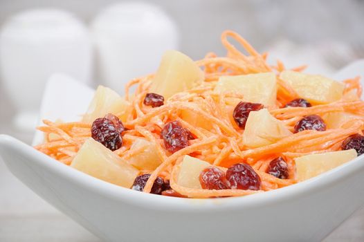 a salad of pineapple, fresh carrots, dried cranberries, yogurt dressed. Gluten free  vegan .