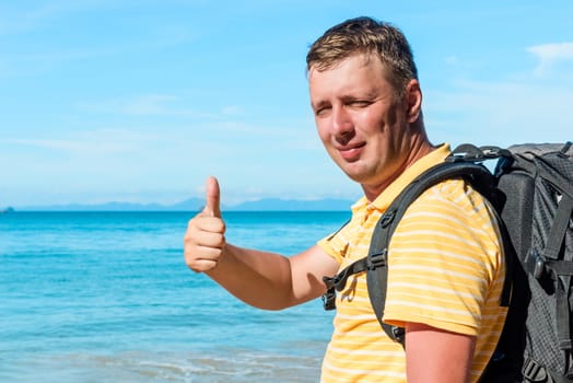 Portrait of a happy traveler on the sea background