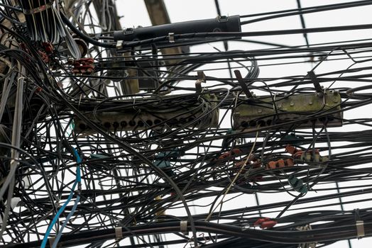 randomly hanging wires on electrical poles in Thailand closeup