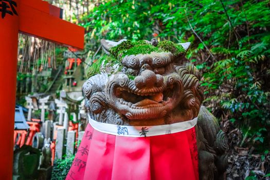 Lion statue at Fushimi Inari Taisha torii shrine, Kyoto, Japan