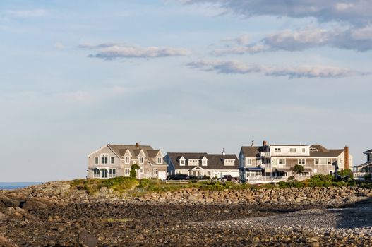 Houses near the coastline with blue and clean sky in Maine, USA