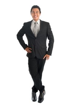 Full body portrait of happy young Southeast Asian businessman standing isolated on white background. 