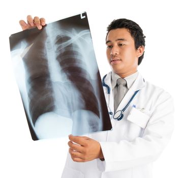 Attractive young male Southeast Asian medical doctor examining xray scan image, standing isolated on white background.
