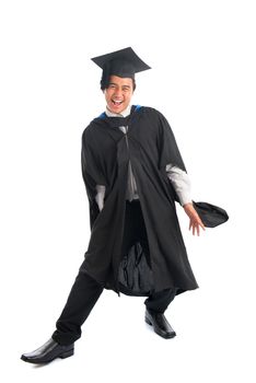 Full body excited Asian male university student in graduation gown jumping high, isolated on white background.