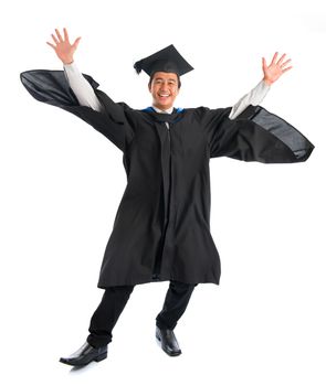 Full body excited Asian male university student in graduation gown jumping high, isolated on white background. Good Looking Southeast model.