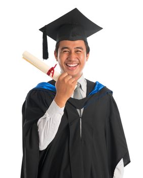 Waist up happy Asian male university student in graduation gown showing certificate , isolated on white background. Good looking Southeast model.