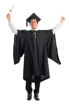 Full body excited Asian male university student in graduation gown arms raised, isolated on white background. Good looking Southeast model.
