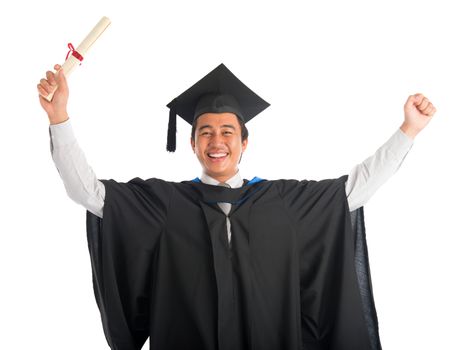 Waist up happy Asian male university student in graduation gown showing certificate , isolated on white background. Good looking Southeast model.