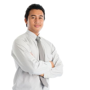 Portrait of cool Southeast Asian businessman arms crossed, standing isolated on white background.