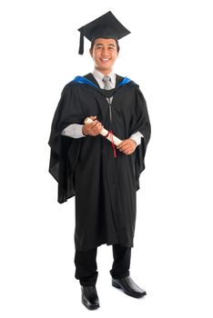 Full body happy Asian male university student in graduation gown smiling, isolated on white background. Good looking Southeast model.
