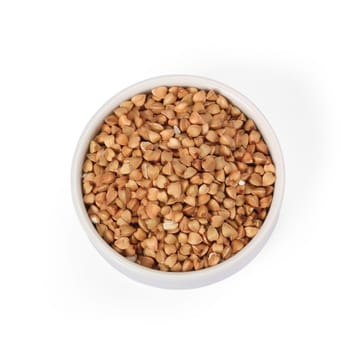 Buckwheat groats in whitebowl isolated on white background.