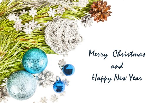 New Year composition with fir tree branch and cones with blue balls and tinsel isolated on white background