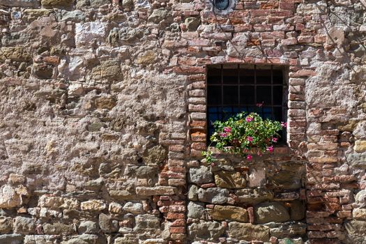 Assisi (Italy): Window on medieval stone wall