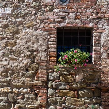 Assisi (Italy): Window on medieval stone wall