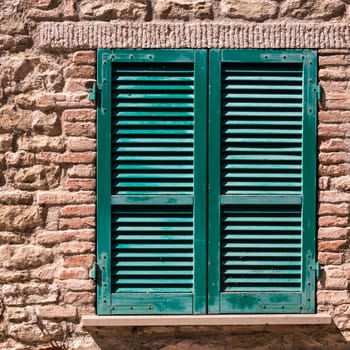 Assisi (Italy): Window on medieval stone wall