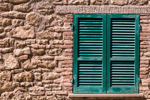 Assisi (Italy): Window on medieval stone wall