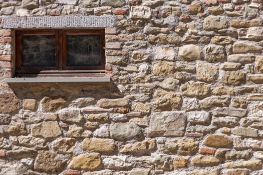 Assisi (Italy): Window on medieval stone wall