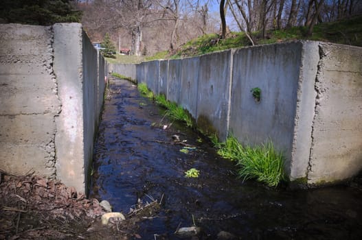Water stream surrounded by concrete wall