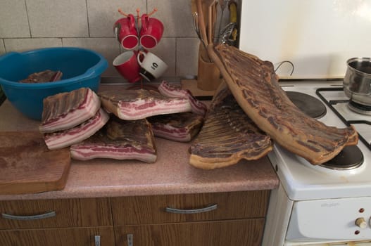 Smoked and dried pork bacon on kitchen table