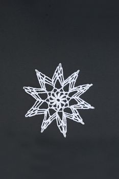 Crocheted star or christmas star, isolated on black