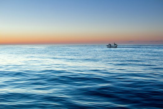 Sunset sunrise in open sea with dramatic cloudy calm clear sky