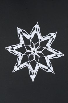 Crocheted star or christmas star, isolated on black