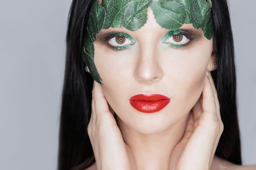 Fashion Art Portrait .Green Make-up and Colorful Bright Nails.