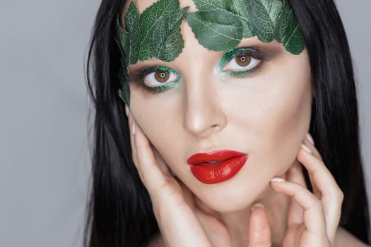 Fashion Art Portrait .Green Make-up and Colorful Bright Nails.