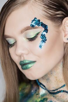 Fashion Art Portrait .Green Make-up and Colorful Bright Nails.