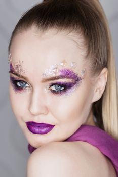 Beauty Makeup. Purple Make-up and Colorful Bright Nails. Beautiful Girl Close-up Portrait.