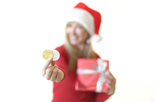 Sydney, Australia - December 17, 2017;  Using cryptocurrency to buy gifts and presents at Christmas.  A woman is holding a bitcoin and a litecoin in her hand and smiling,