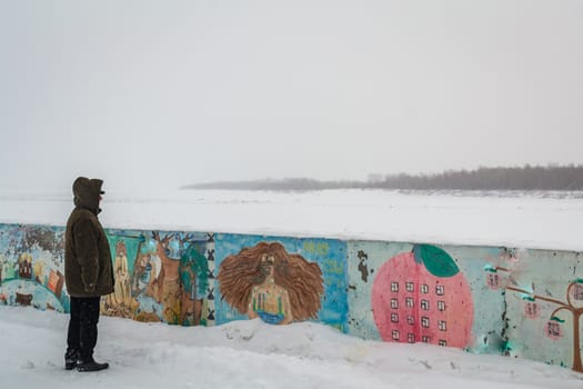 the lone man looks at water winter old man