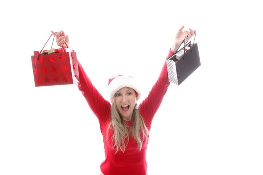 A woman holding up shopping bags in the Christmas season.  