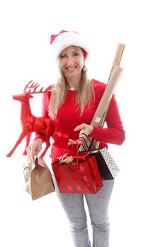 A woman holding various gifts, decorations and gift wrap for Christmas
