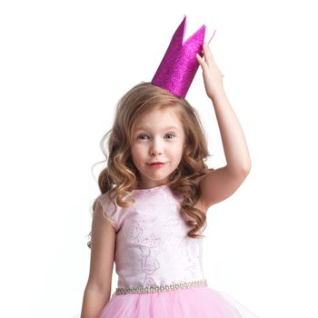 Happy small princess girl in pink dress and crown isolated on white background