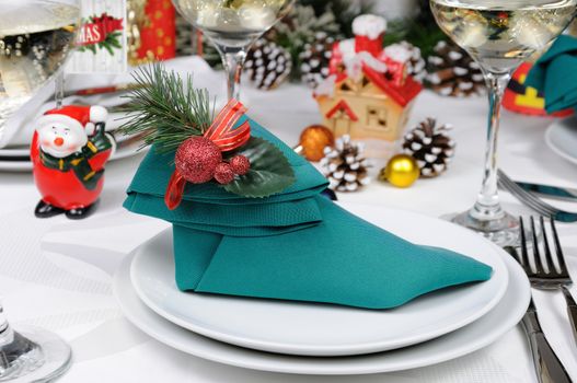 Napkin folded in the form of an Elven boot decorated on the Christmas table