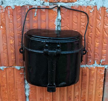 Old restored milk can hanging on wall