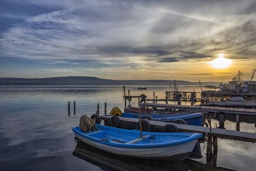 exciting sunset on harbor with boats 