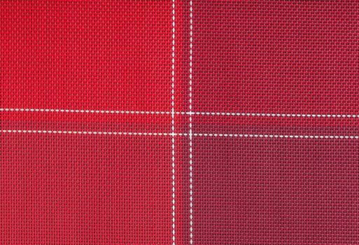 background texture of red cloth with white stitching