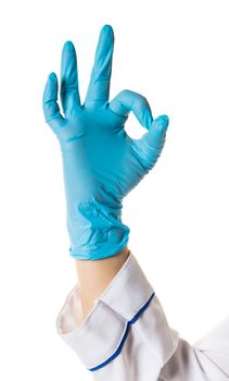 Hand in blue glove isolated on white showing ok sign.