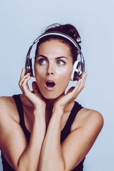 Young smiling woman listening to music with headphones