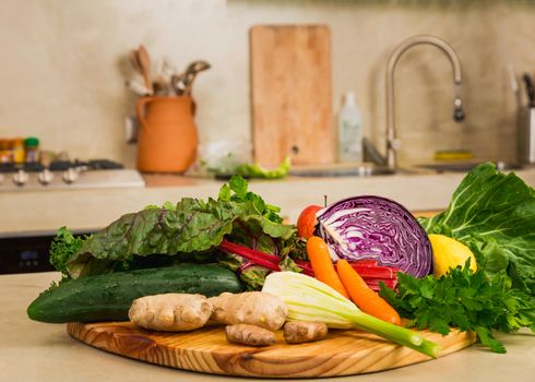 Several vegetables on top of a wooden board. Ingredients for detox diet. 