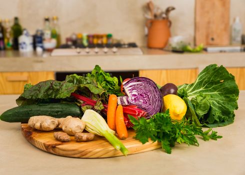Several vegetables on top of a wooden board. Ingredients for detox diet. 