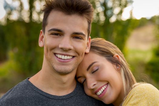 Portrait of a young beautiful couple hugged together